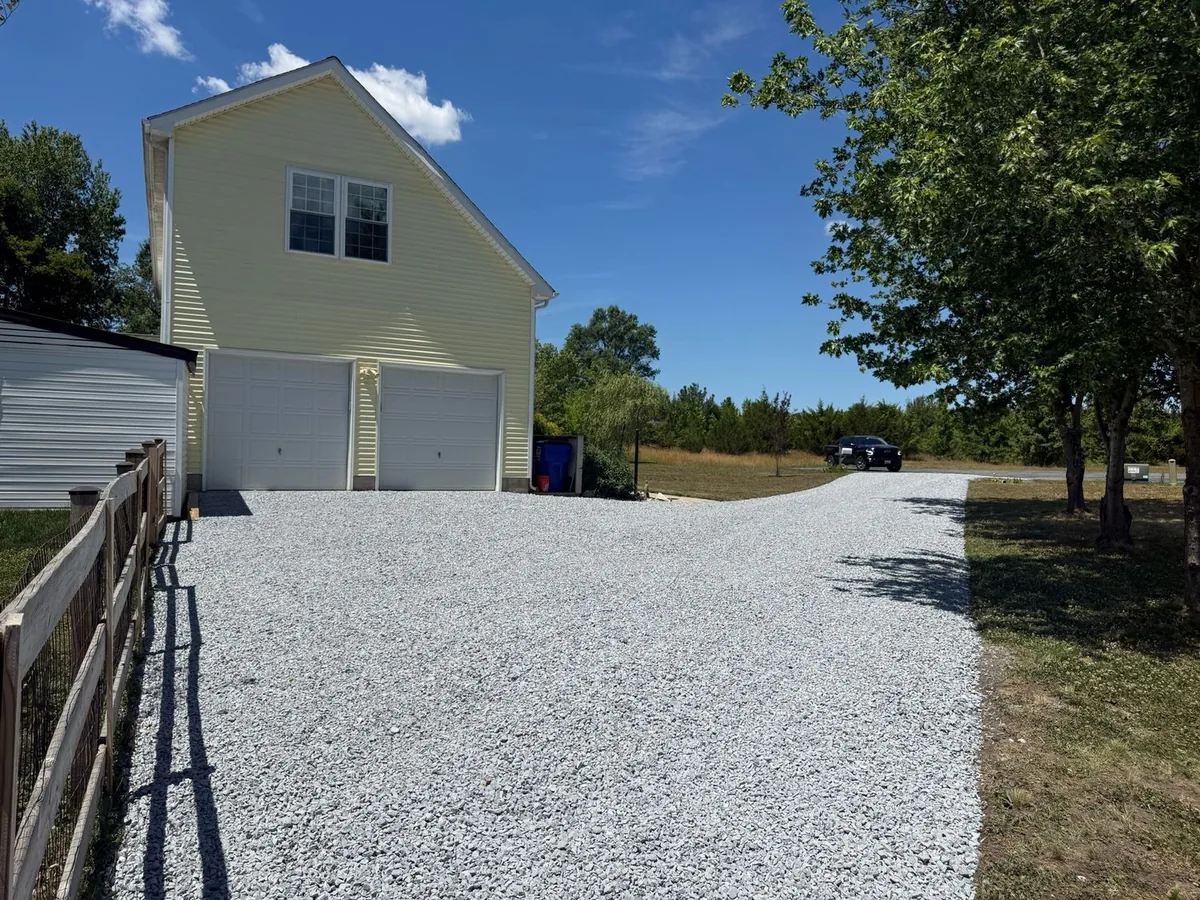 Fresh white limestone driveway leading up to a detached garage